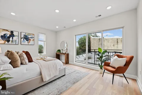 a bedroom with a bed and a painting on the wall