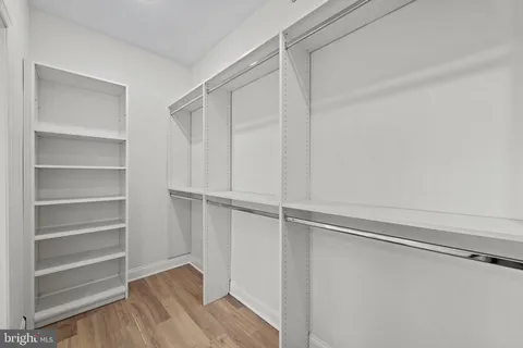 a view of an empty room with wooden stairs