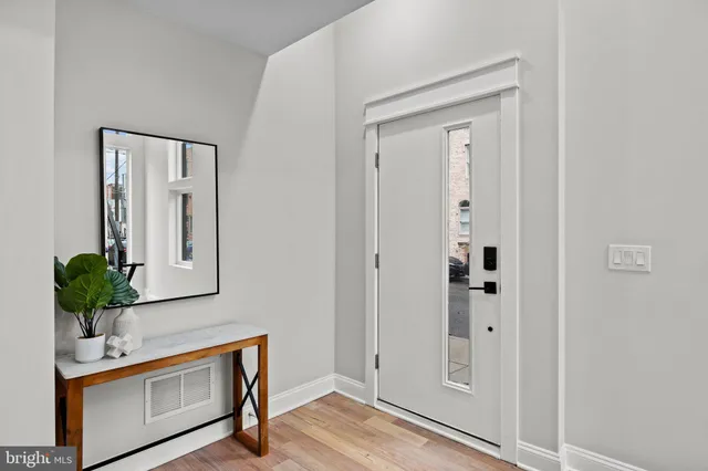 a view of an entryway with wooden floor
