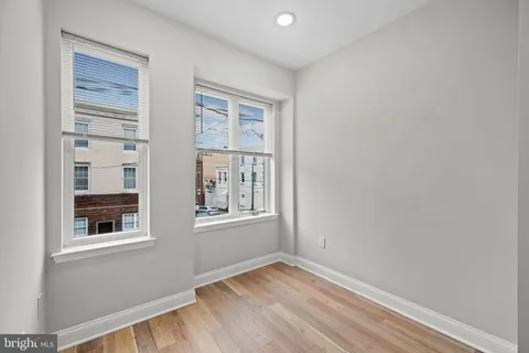 a living room with furniture a table and kitchen view
