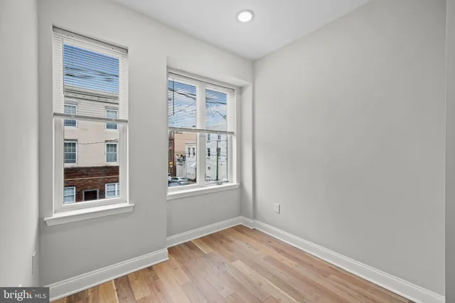 a living room with furniture a table and kitchen view