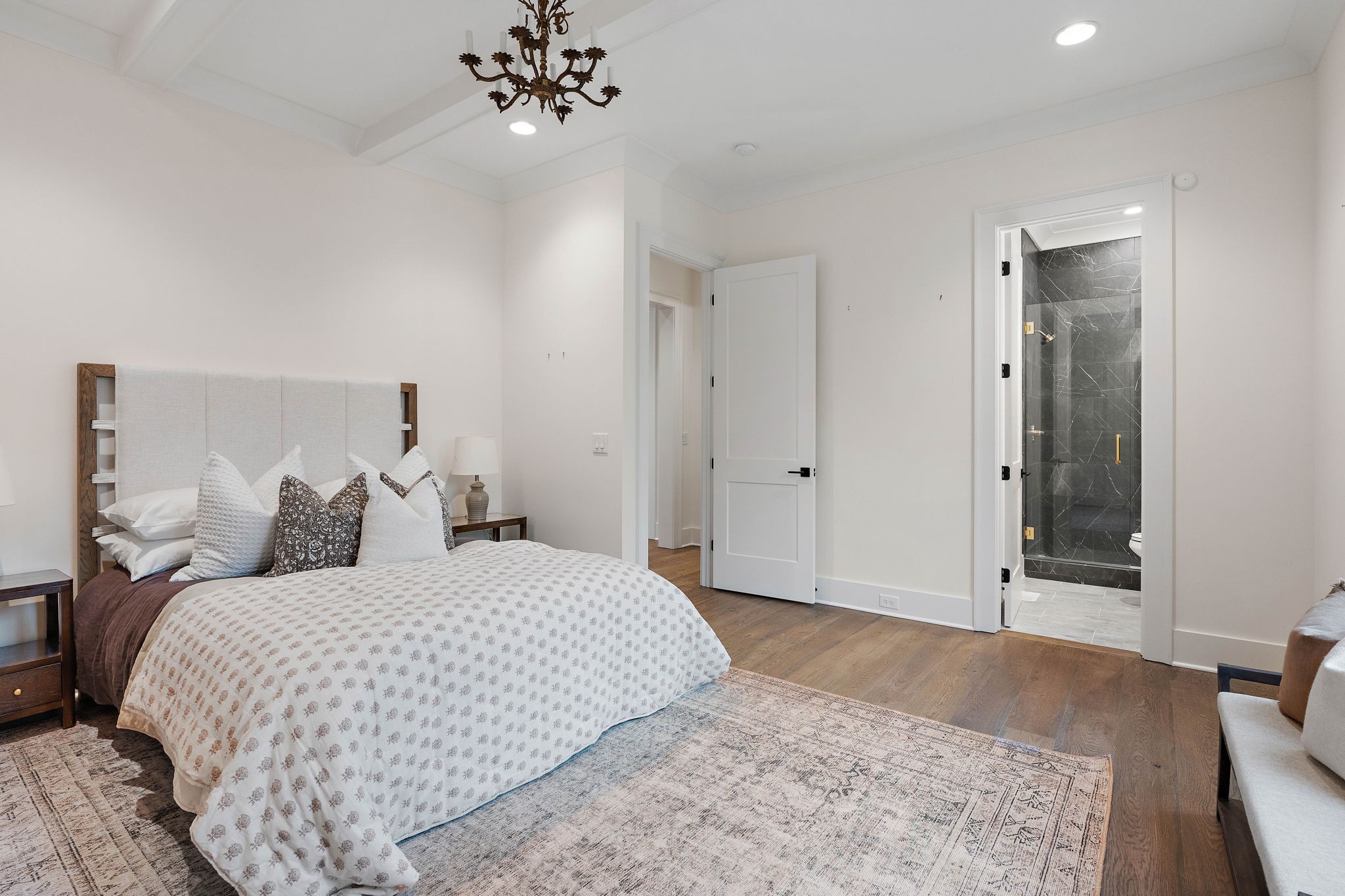 4340 Sneed Road Nashville, TN 37215 - Photo 21 of 49 a bedroom with a large bed and a chandelier