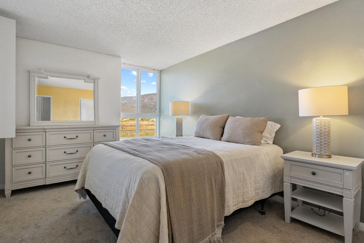 4700 Sandyland Road, Unit 23 Carpinteria, CA 93013 - Photo 17 of 26 a bedroom with a bed and a dresser