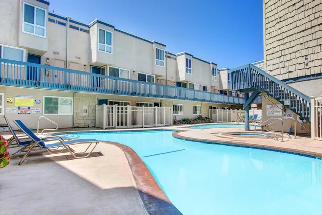 a view of a swimming pool with a chair and tables