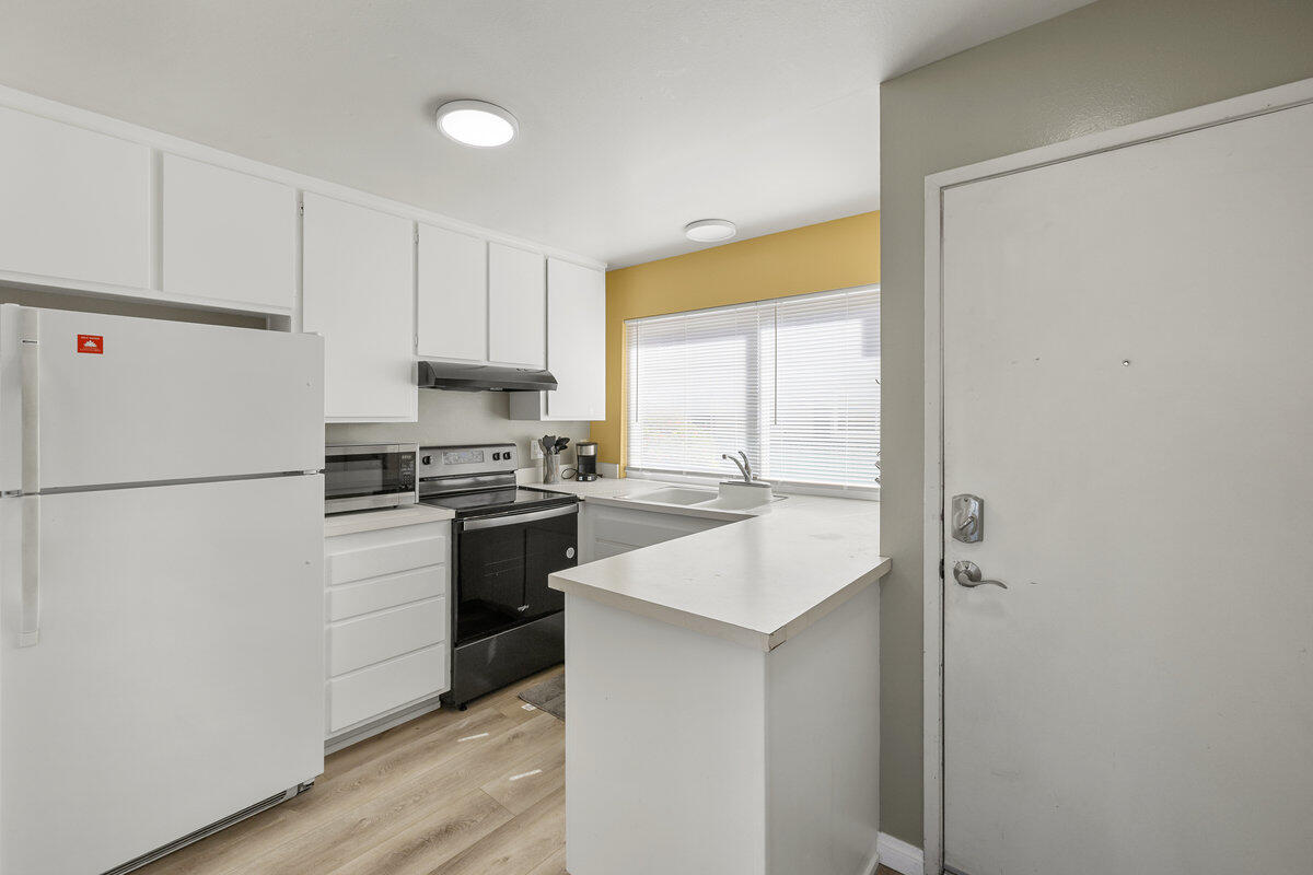 4700 Sandyland Road, Unit 23 Carpinteria, CA 93013 - Photo 4 of 26 a kitchen with a refrigerator a stove a sink and a window