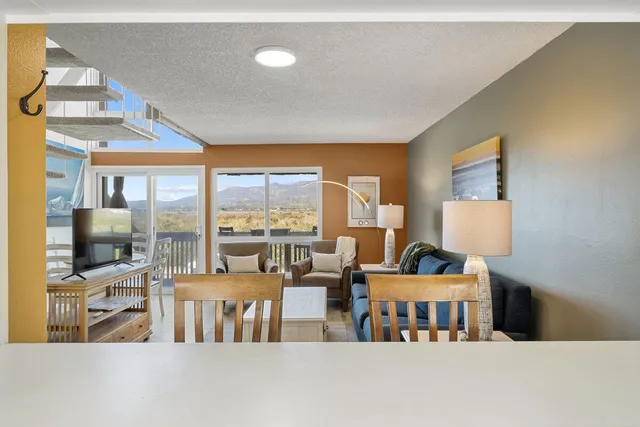 a living room with furniture and a floor to ceiling window