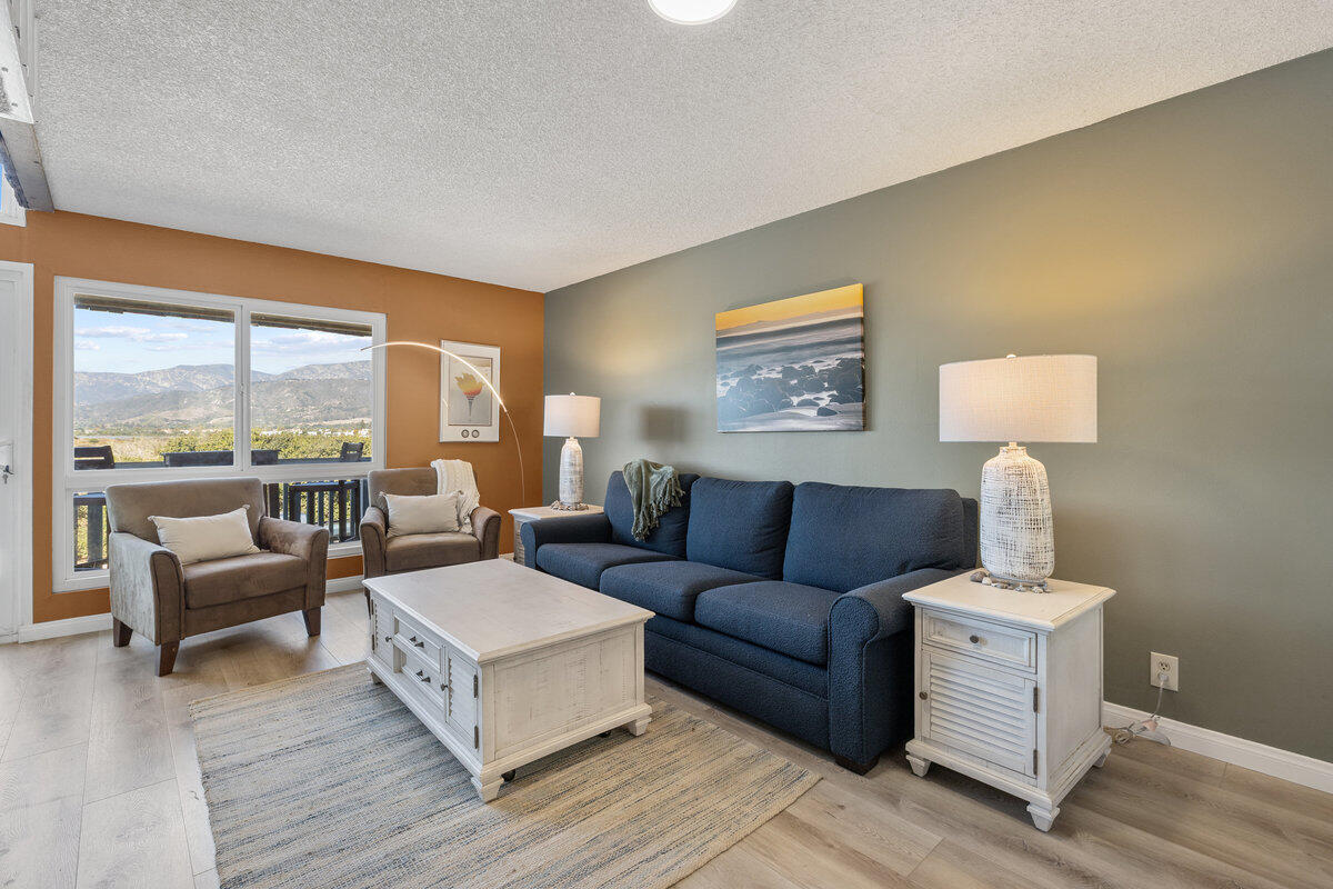 4700 Sandyland Road, Unit 23 Carpinteria, CA 93013 - Photo 8 of 26 a living room with furniture and a lamp