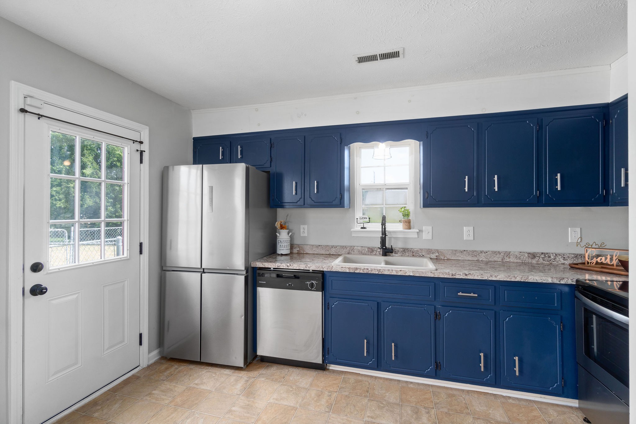 963 State Line Road Oak Grove, KY 42262 - Photo 17 of 33 a kitchen with a sink a refrigerator and wooden cabinets