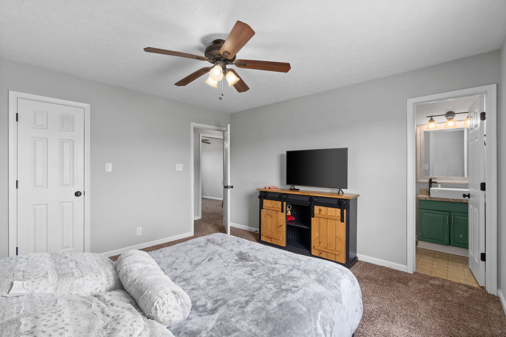 963 State Line Road Oak Grove, KY 42262 - Photo 24 of 33 a bedroom with a bed and a flat screen tv