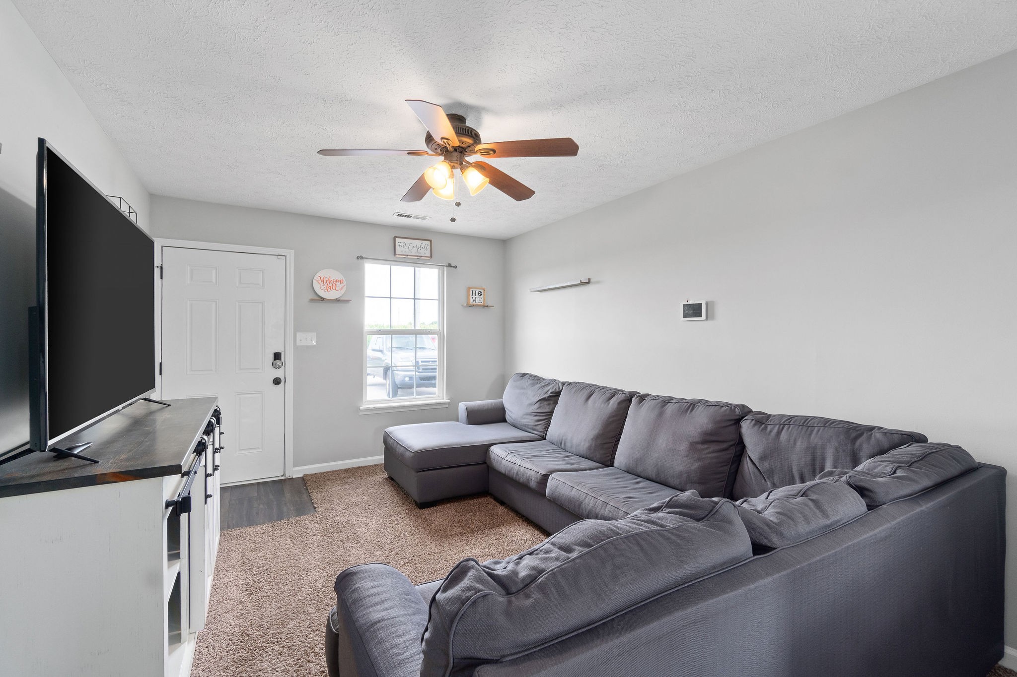 963 State Line Road Oak Grove, KY 42262 - Photo 7 of 33 a living room with furniture and a flat screen tv