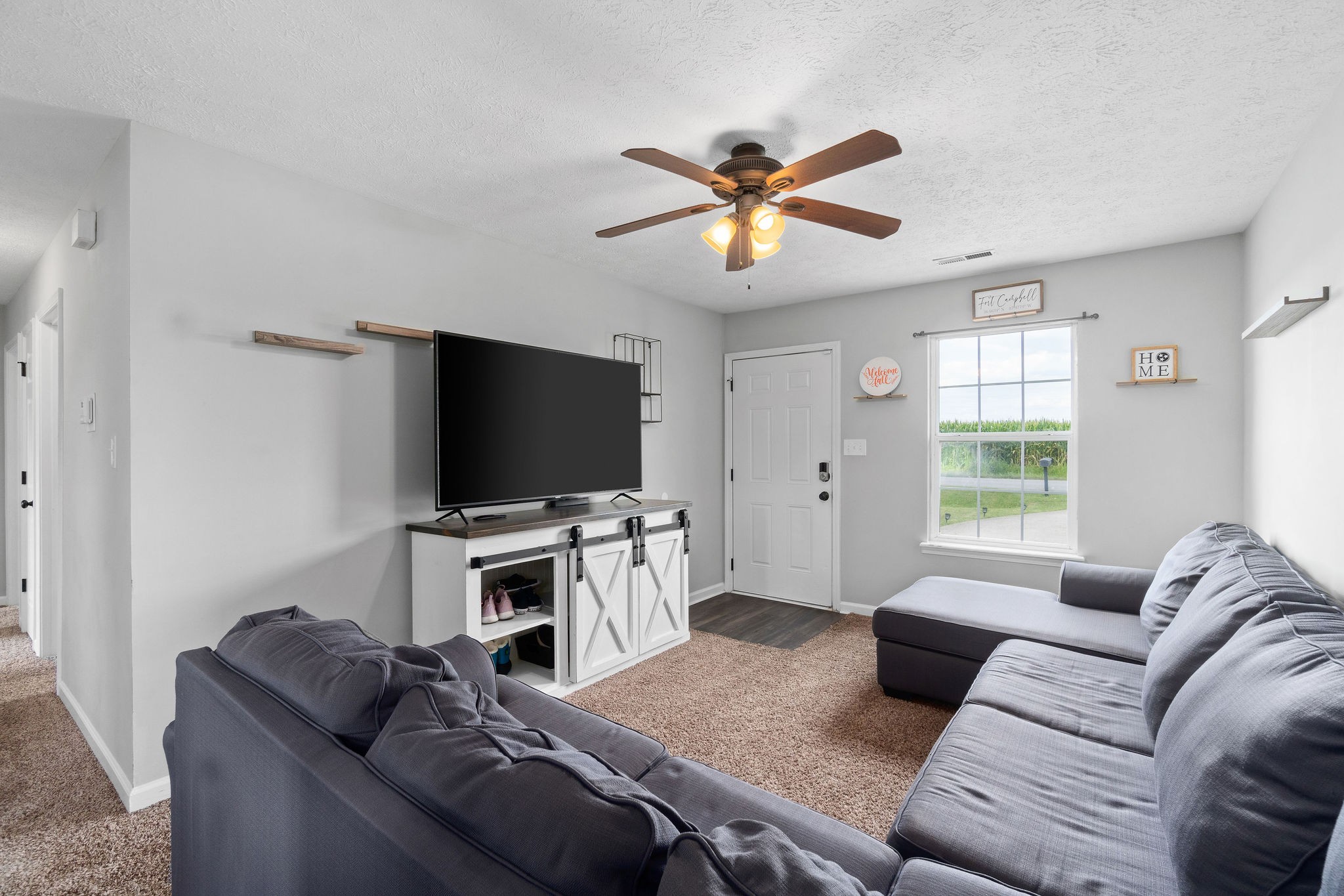 963 State Line Road Oak Grove, KY 42262 - Photo 8 of 33 a living room with furniture and a flat screen tv