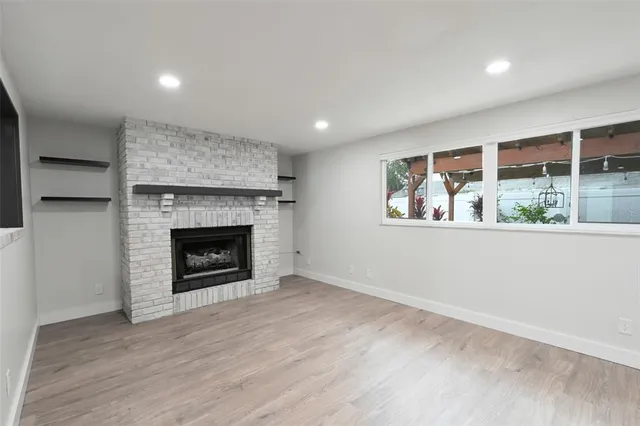 a view of an empty room with a fireplace