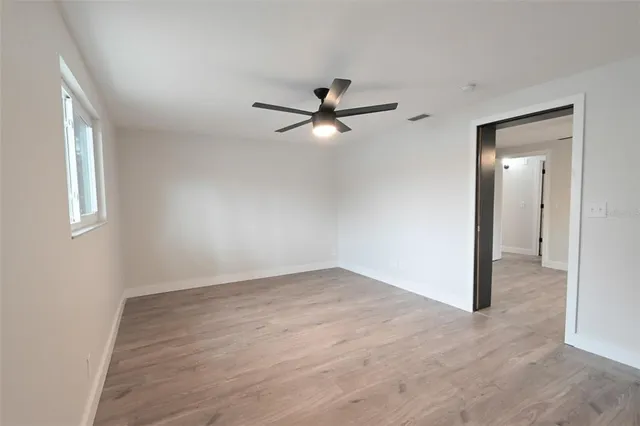 wooden floor in an empty room with a window