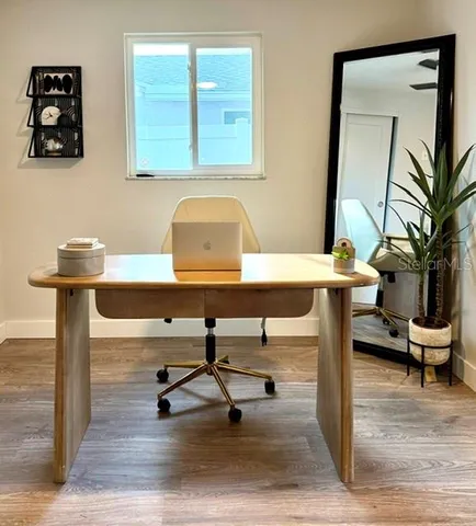 a view of a livingroom with furniture and a potted plant