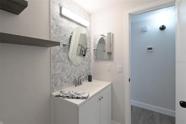 a bathroom with a sink and mirror