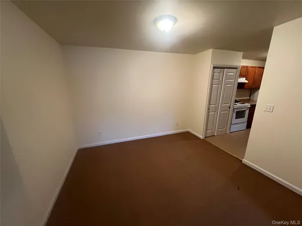 an empty room with furniture and wooden floor