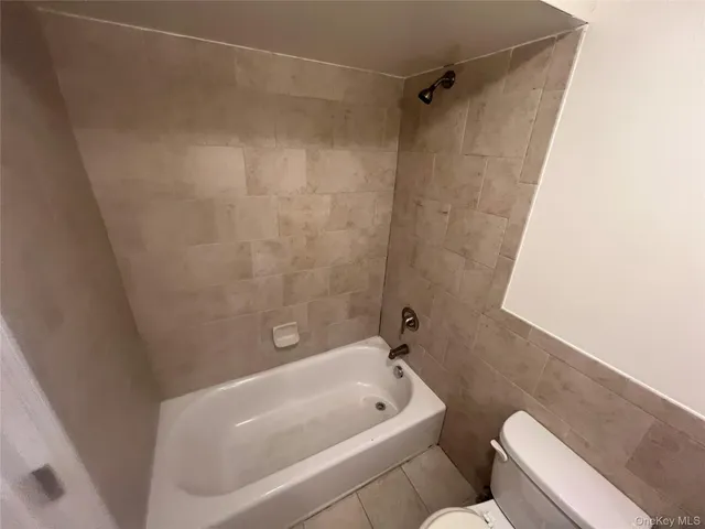 a bathroom with a bathtub and shower