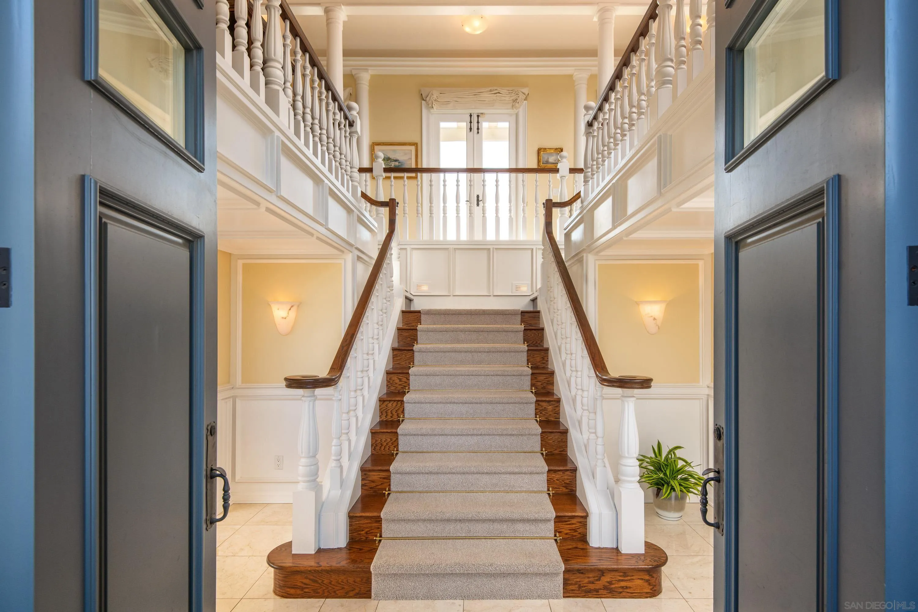 3023 Paseo Cielo Rancho Santa Fe, CA 92067 - Photo 11 of 33 a view of staircase with lots of frames on wall and a potted plant