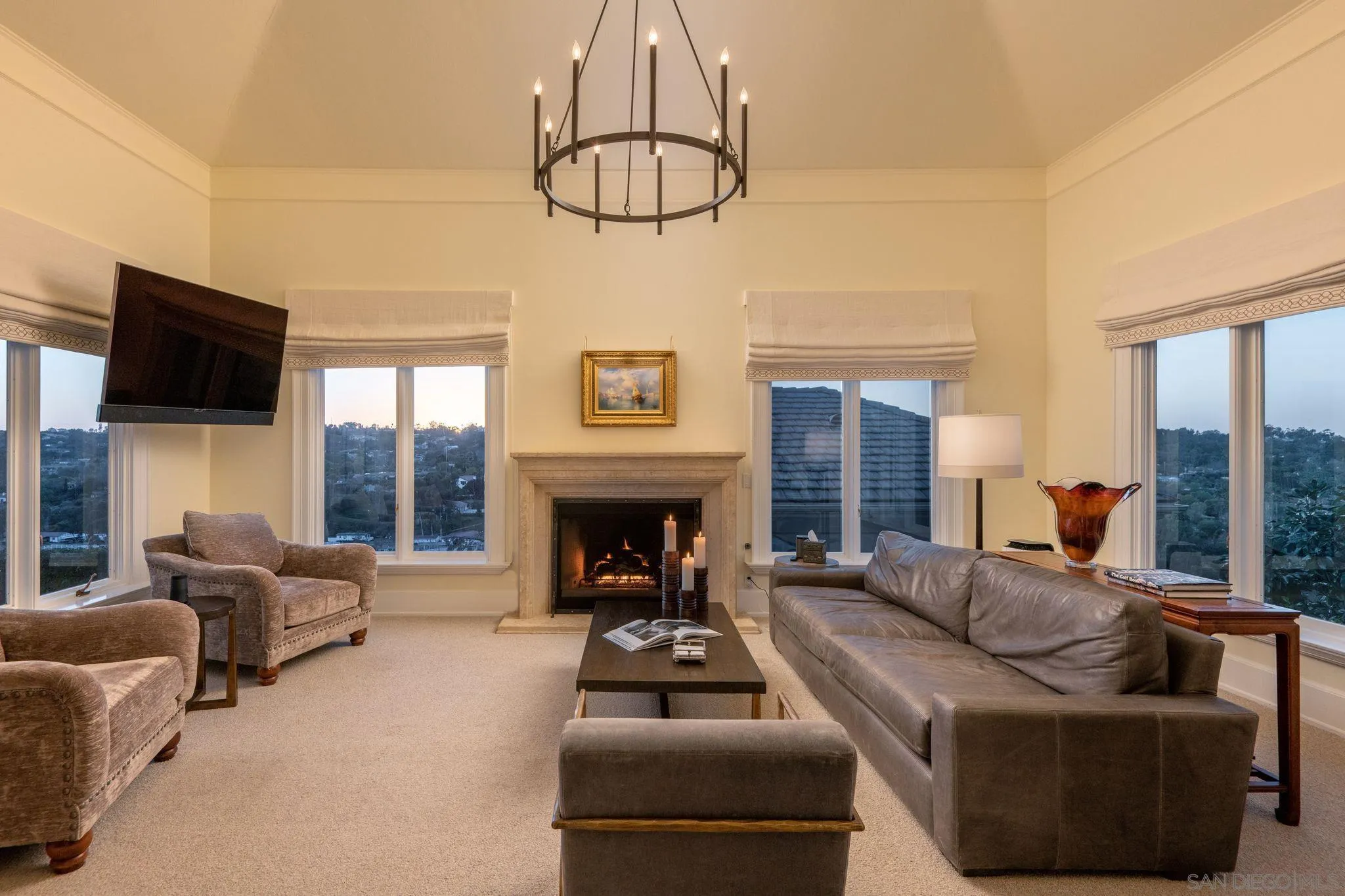 3023 Paseo Cielo Rancho Santa Fe, CA 92067 - Photo 16 of 33 a living room with furniture a fireplace a flat screen tv and a large window