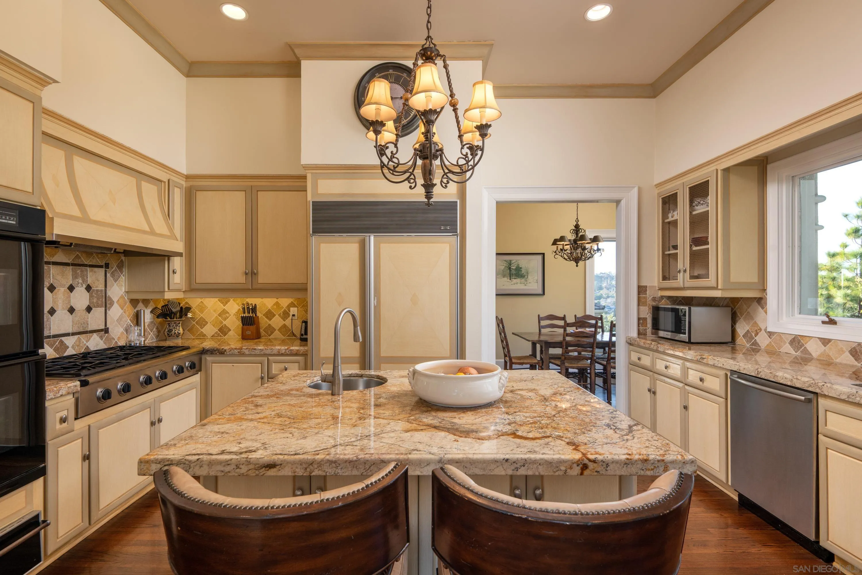 3023 Paseo Cielo Rancho Santa Fe, CA 92067 - Photo 18 of 33 a kitchen with sink a stove and chairs