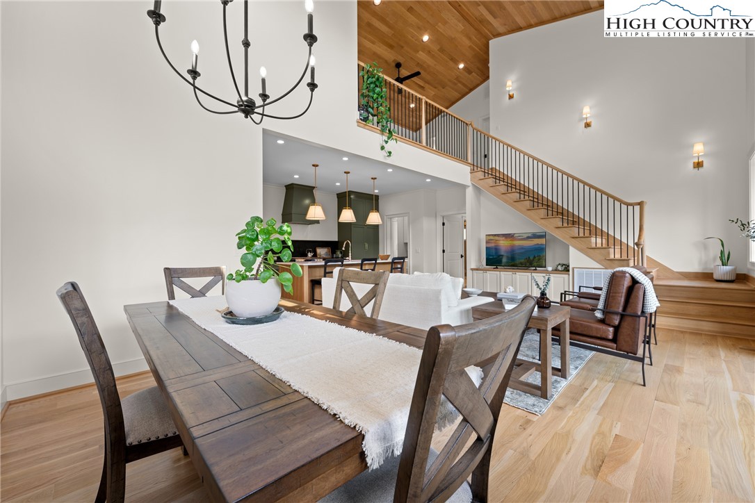 2181 Broadstone Road Banner Elk, NC 28604 - Photo 11 of 38 a dining room with furniture a potted plant and wooden floor