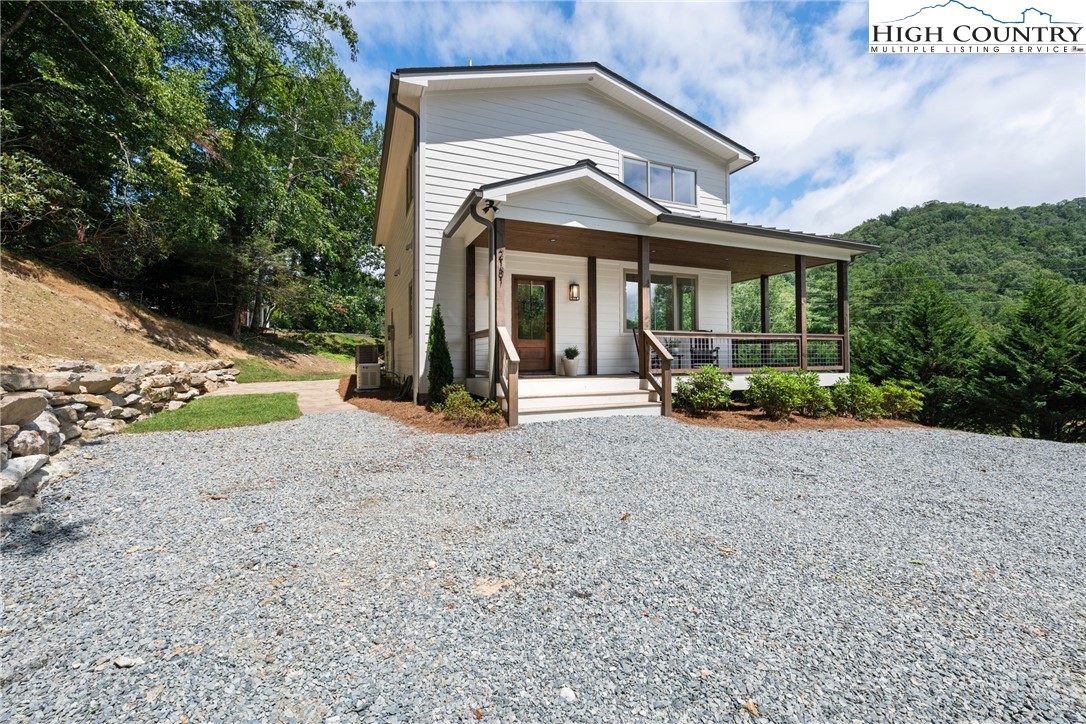 2181 Broadstone Road Banner Elk, NC 28604 - Photo 2 of 38 a view of a house with backyard and porch