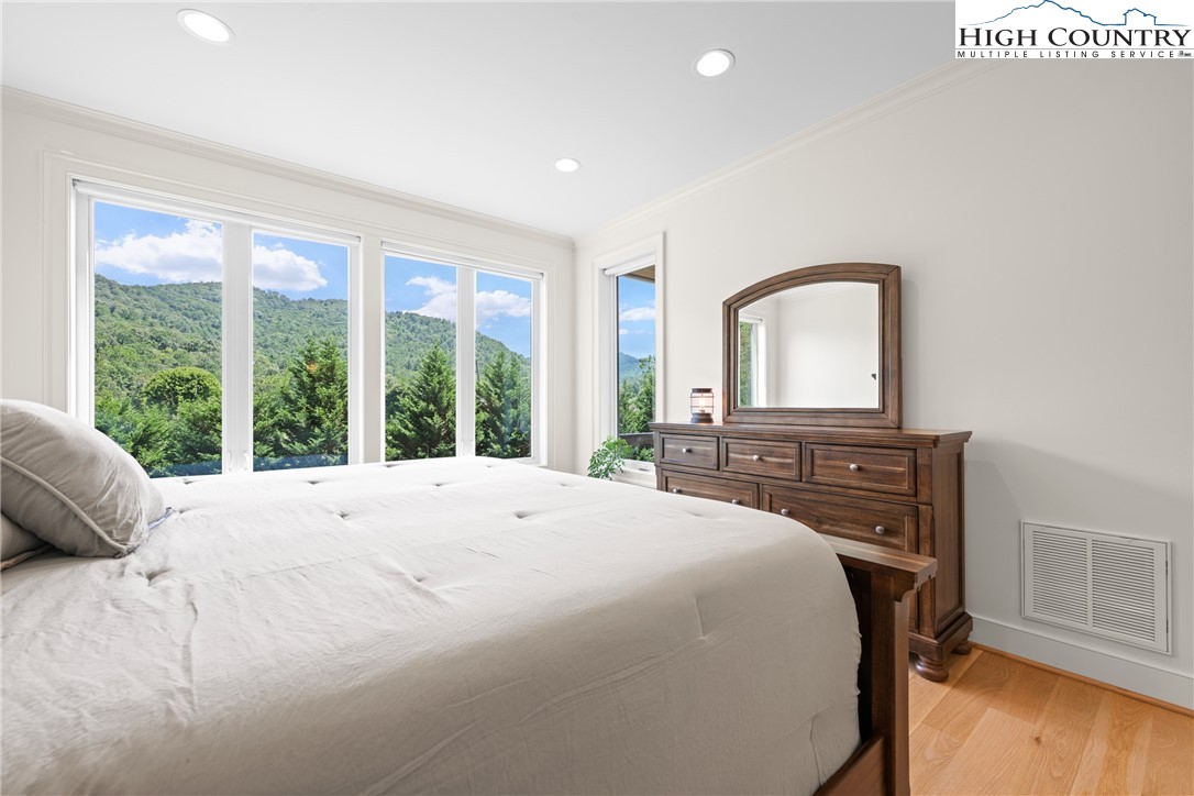 2181 Broadstone Road Banner Elk, NC 28604 - Photo 21 of 38 a bedroom with a bed and a large window