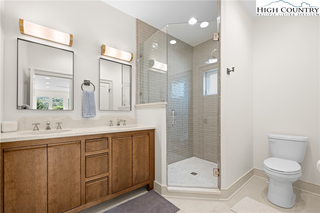 2181 Broadstone Road Banner Elk, NC 28604 - Photo 23 of 38 a bathroom with a double vanity sink toilet and shower