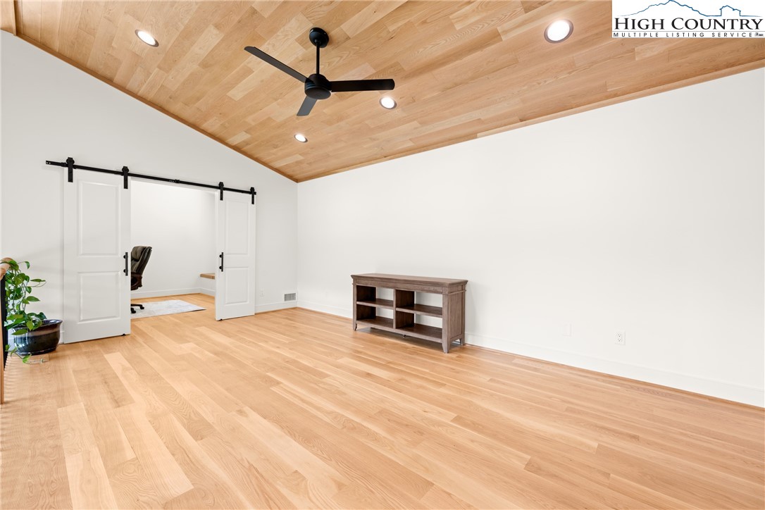2181 Broadstone Road Banner Elk, NC 28604 - Photo 26 of 38 a view of a livingroom with a ceiling fan and wooden floor
