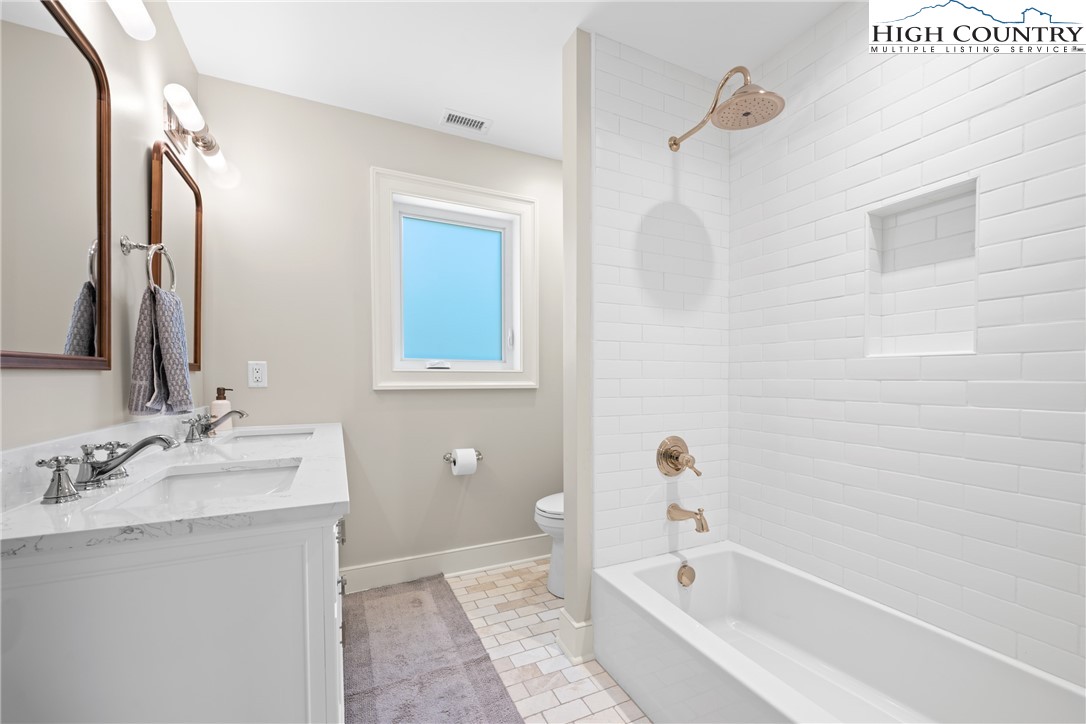 2181 Broadstone Road Banner Elk, NC 28604 - Photo 28 of 38 a bathroom with a tub sink and mirror