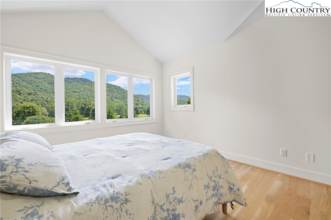2181 Broadstone Road Banner Elk, NC 28604 - Photo 29 of 38 a view of a bedroom with a bed and wooden floor