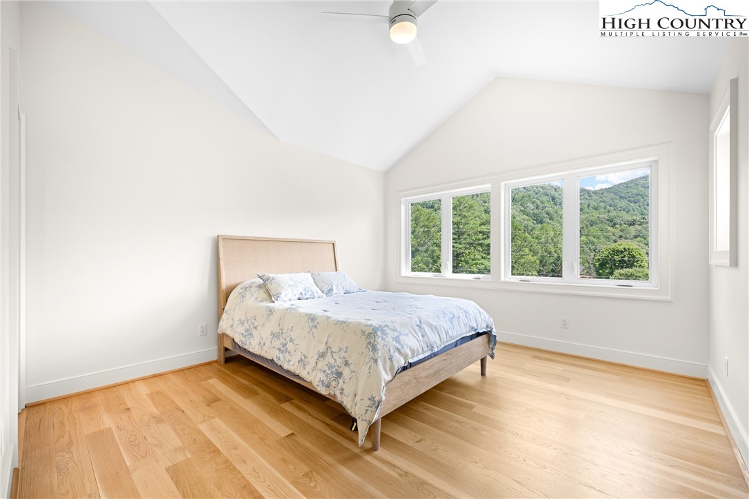 2181 Broadstone Road Banner Elk, NC 28604 - Photo 30 of 38 a bed sitting in a bedroom next to a window