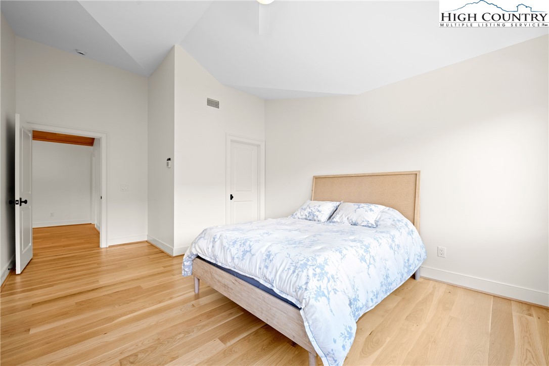 2181 Broadstone Road Banner Elk, NC 28604 - Photo 31 of 38 a bedroom with a bed and wooden floor