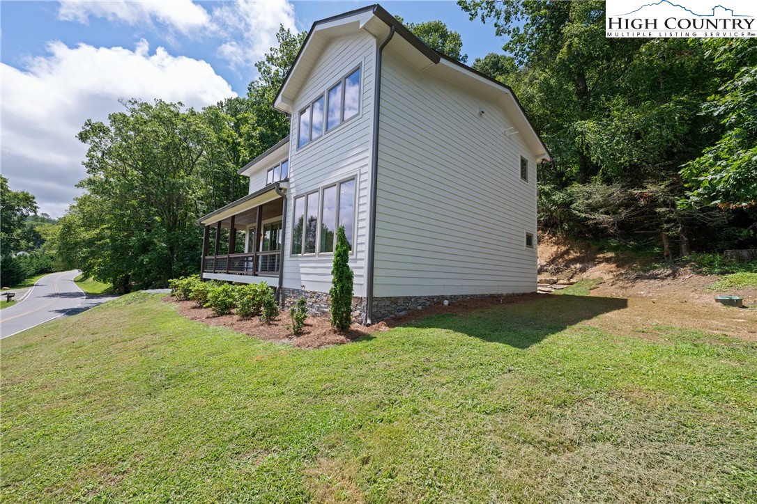 2181 Broadstone Road Banner Elk, NC 28604 - Photo 34 of 38 a view of a house with backyard and sitting area