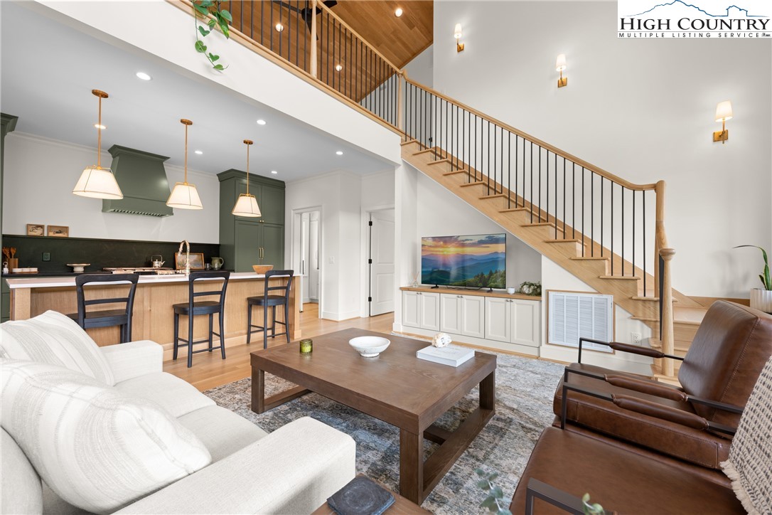 2181 Broadstone Road Banner Elk, NC 28604 - Photo 10 of 38 a living room with furniture kitchen view and a wooden floor