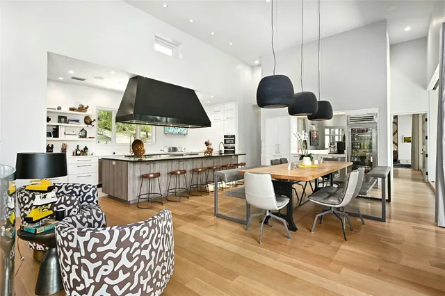a kitchen with stainless steel appliances a dining table and chairs