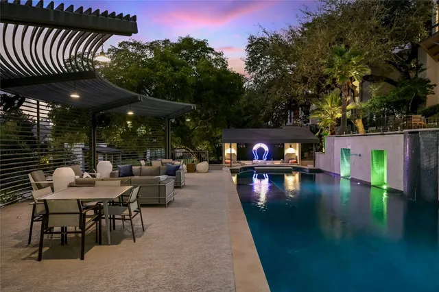 a view of swimming pool with outdoor seating and plants