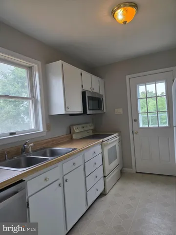 a kitchen that has a sink and a stove