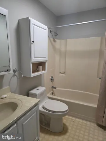 a bathroom with a toilet sink and shower