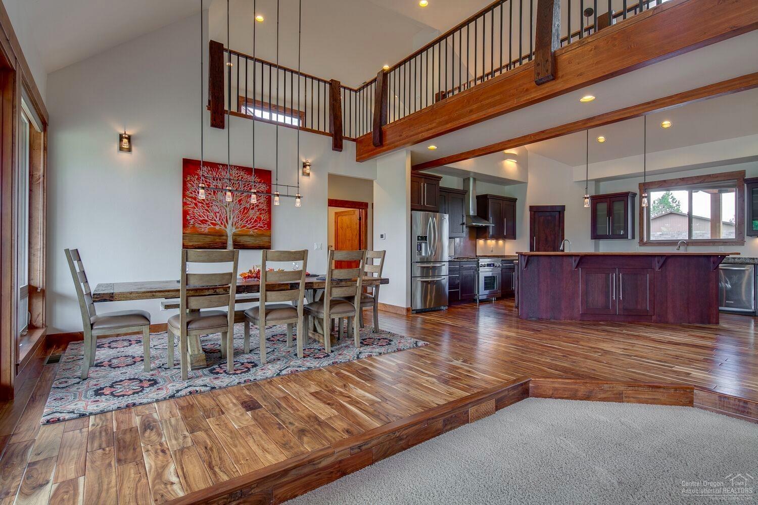 62855 Dickey Road Bend, OR 97701 - Photo 6 of 25 a view of a dining room with furniture a chandelier and wooden floor