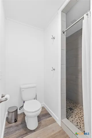 a white toilet sitting next to a bathroom sink