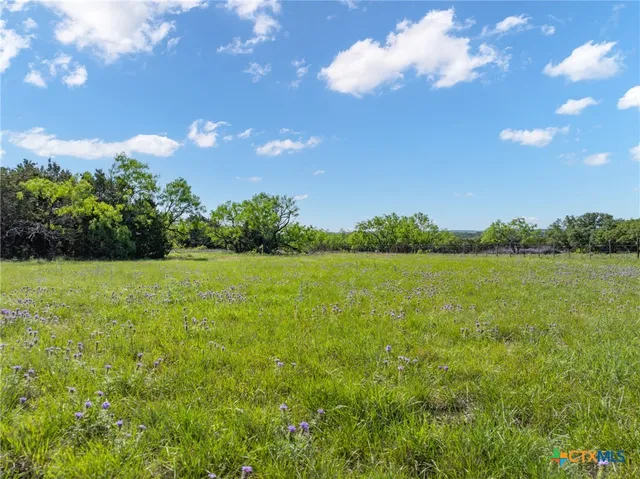 a view of a lake with a house in the background