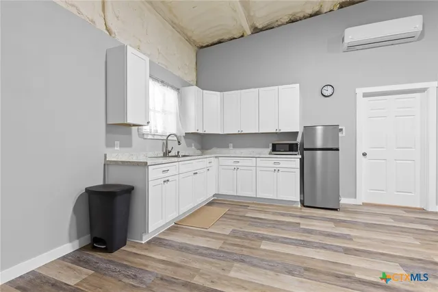 a kitchen with stainless steel appliances granite countertop a refrigerator sink and cabinets