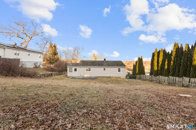 a view of a dry yard with a house