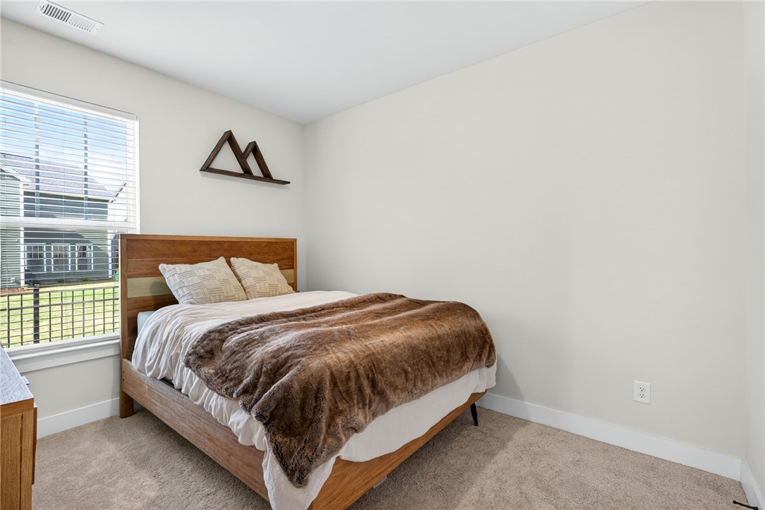 128 Whitman Way Easley, SC 29642 - Photo 16 of 34 This cozy bedroom features a bright window and comfortable carpet.