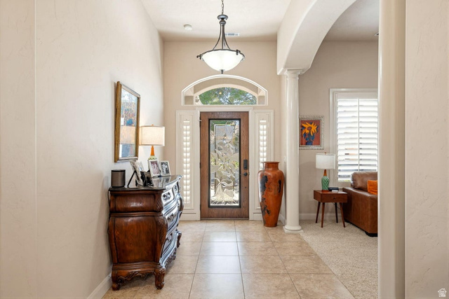 1609 East 10 S Street St. George, UT 84790 - Photo 8 of 68 Entryway featuring tile flooring, a recessed ceiling, and an arched transom window above the front door