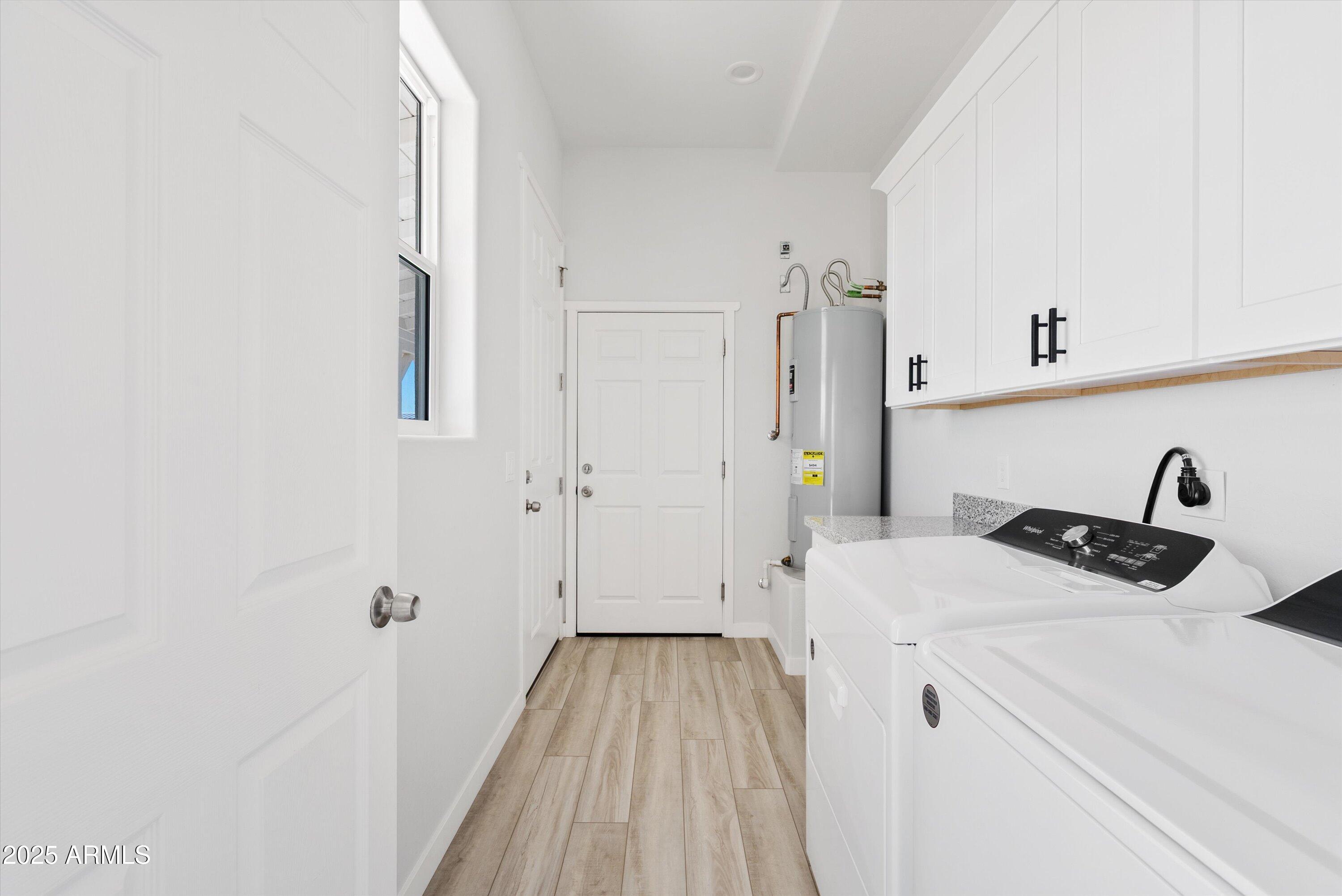 10473 East Dixie Road Florence, AZ 85132 - Photo 17 of 42 a view of a bedroom with a bed and wooden floor