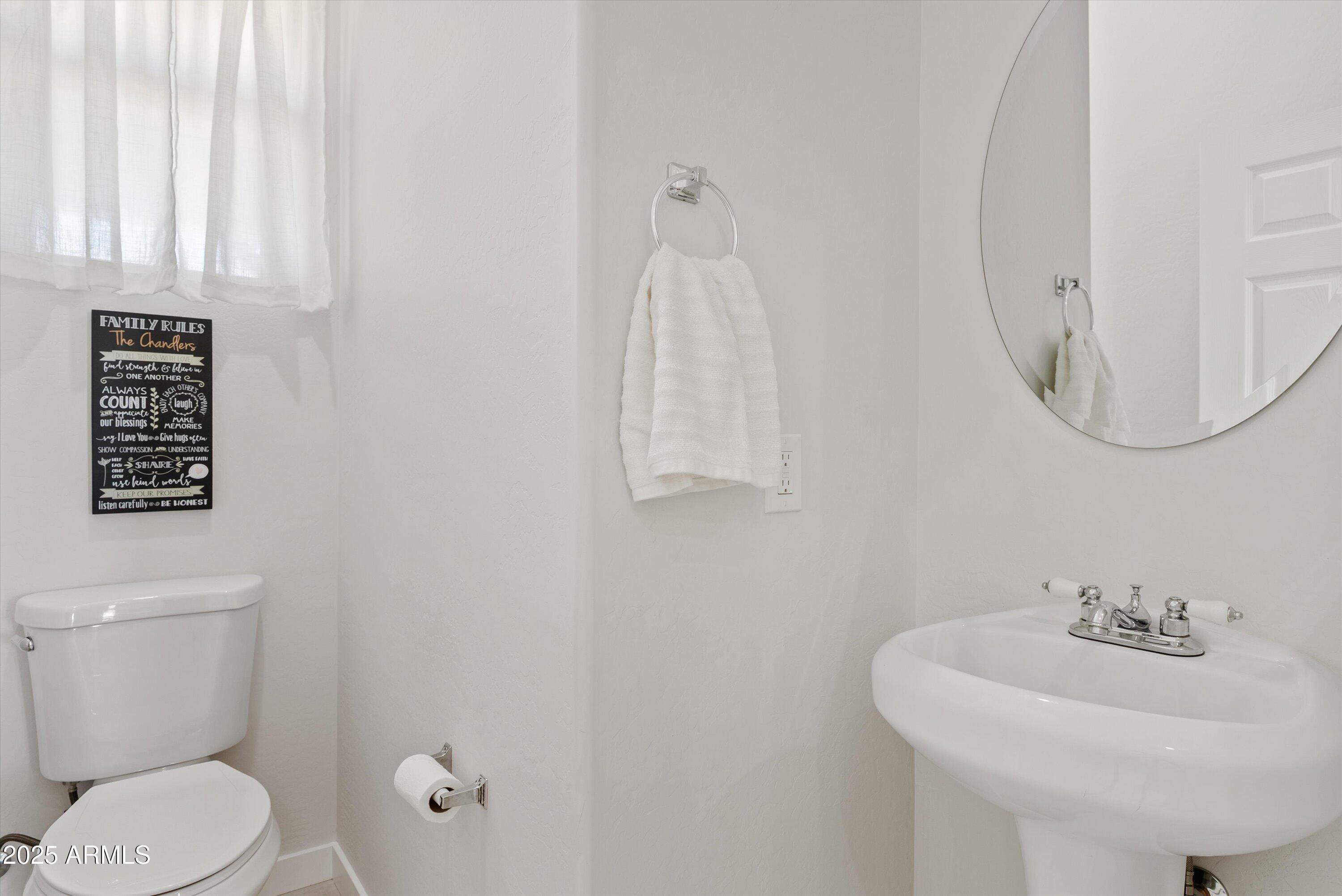10473 East Dixie Road Florence, AZ 85132 - Photo 18 of 42 a bathroom with a sink a toilet and a mirror