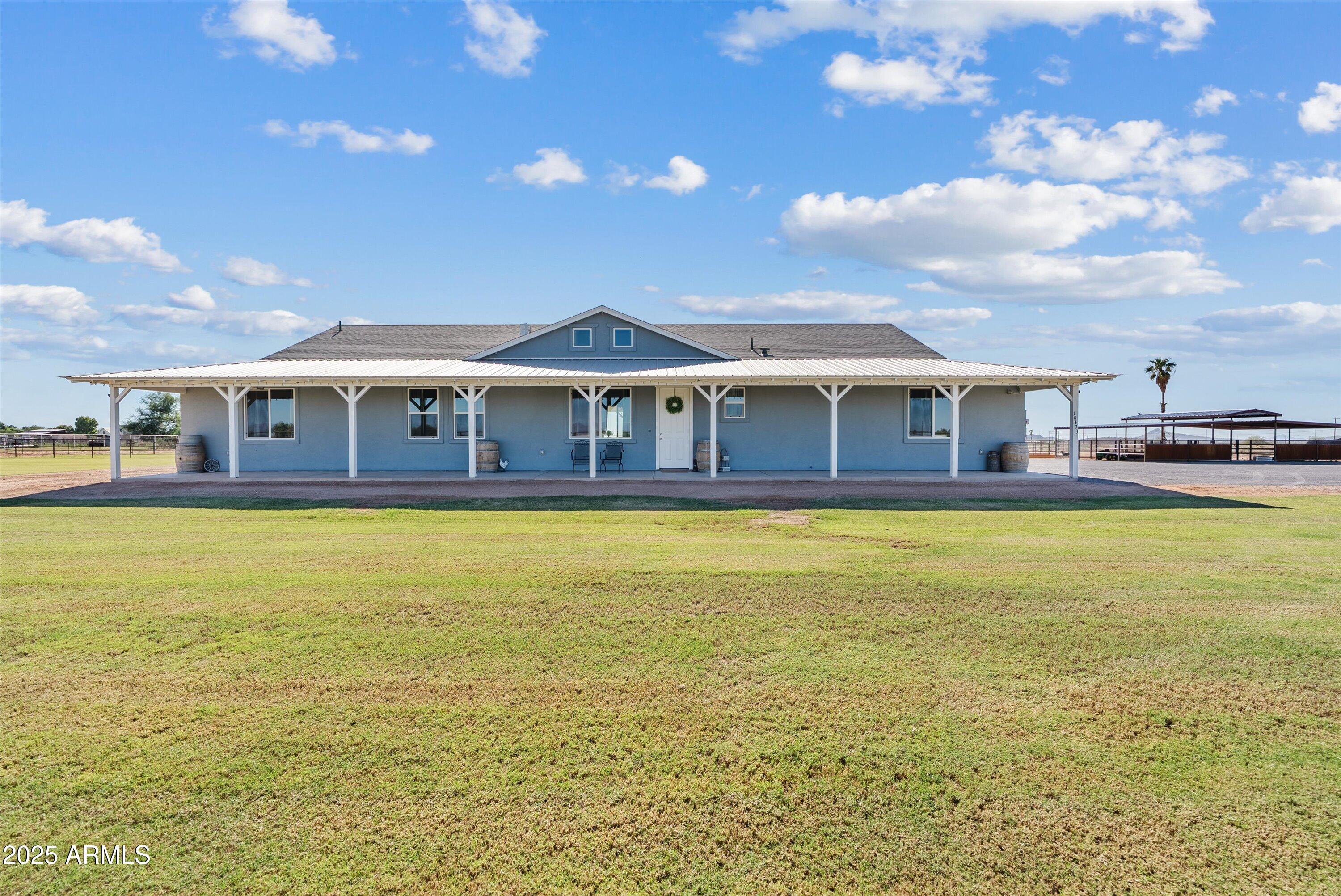 10473 East Dixie Road Florence, AZ 85132 - Photo 2 of 42 a view of a large pool with a lawn chairs and a yard