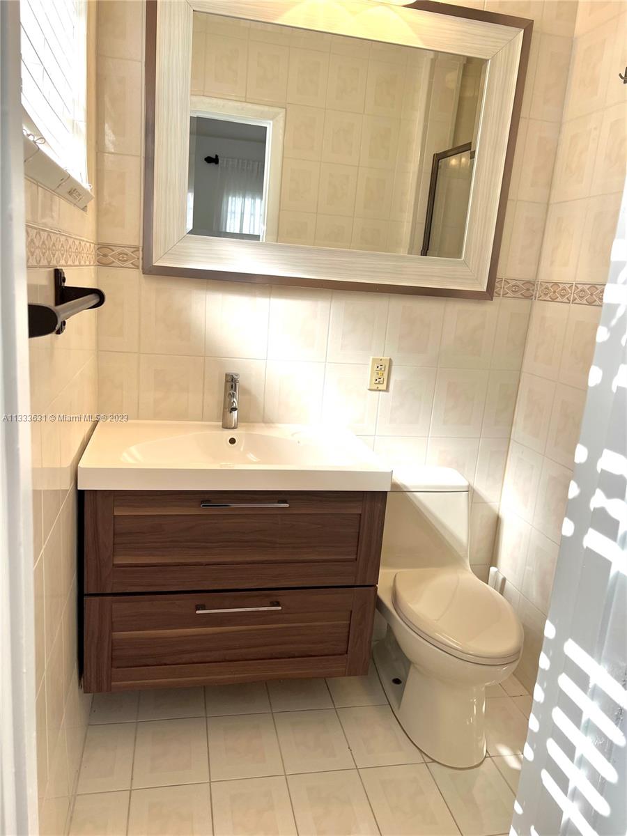 8600 Southwest 33rd Terrace Miami, FL 33155 - Photo 11 of 14 a bathroom with a toilet sink and mirror